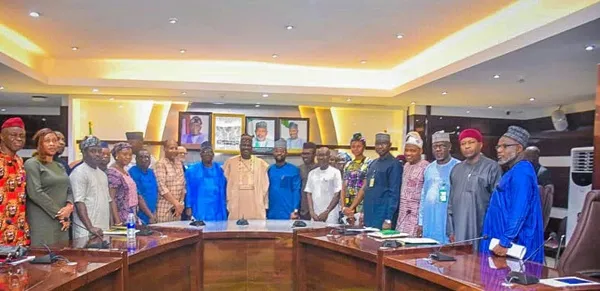 Dr. Aliyu Abdullahi, the Minister of State for Agriculture and Food Security in Nigeria, is pictured with committee members during their inauguration at the ministry headquarters in Abuja.